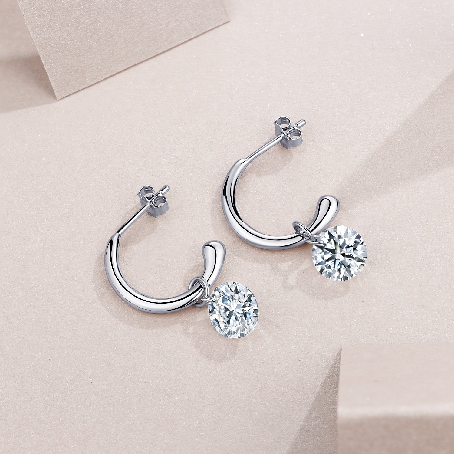 Pair of hinged chunky hoop earrings with round moissanite drops, white gold vermeil
