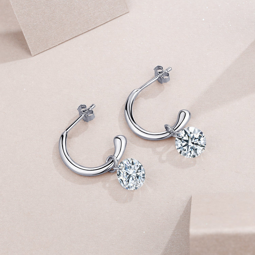 Pair of hinged chunky hoop earrings with round moissanite drops, white gold vermeil