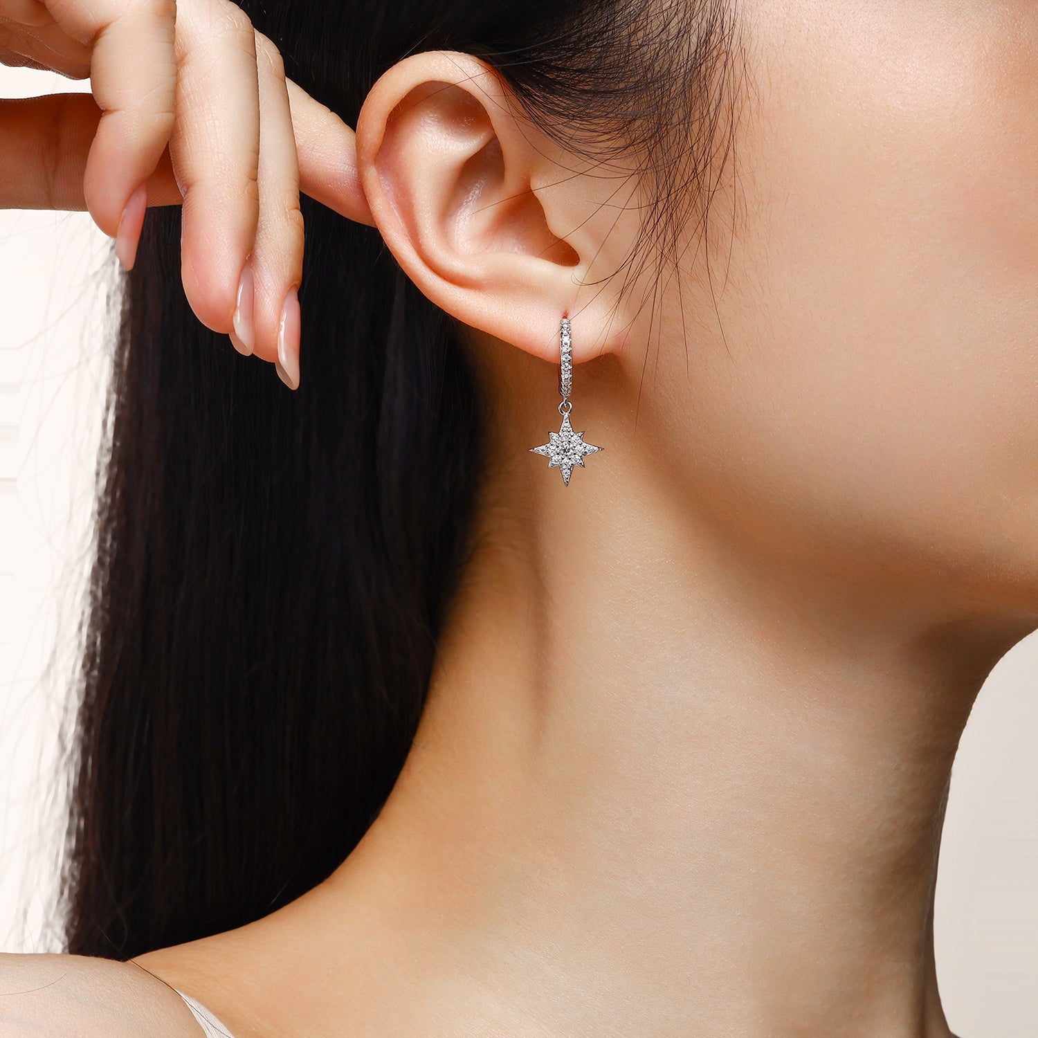 Star drop earring with pavé stones on a white gold vermeil hook