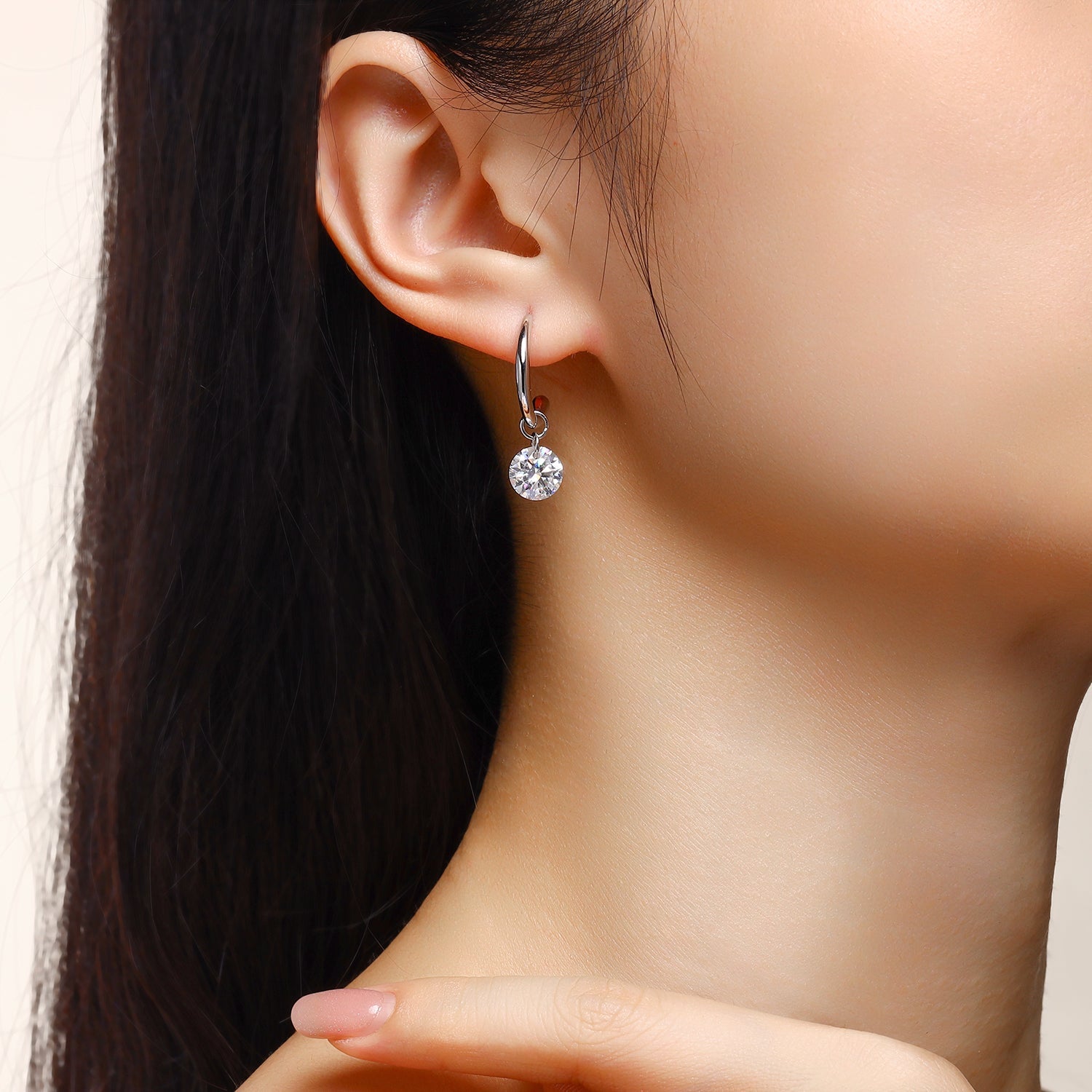 Worn on ear: chunky hoop with small round moissanite charm, white gold vermeil