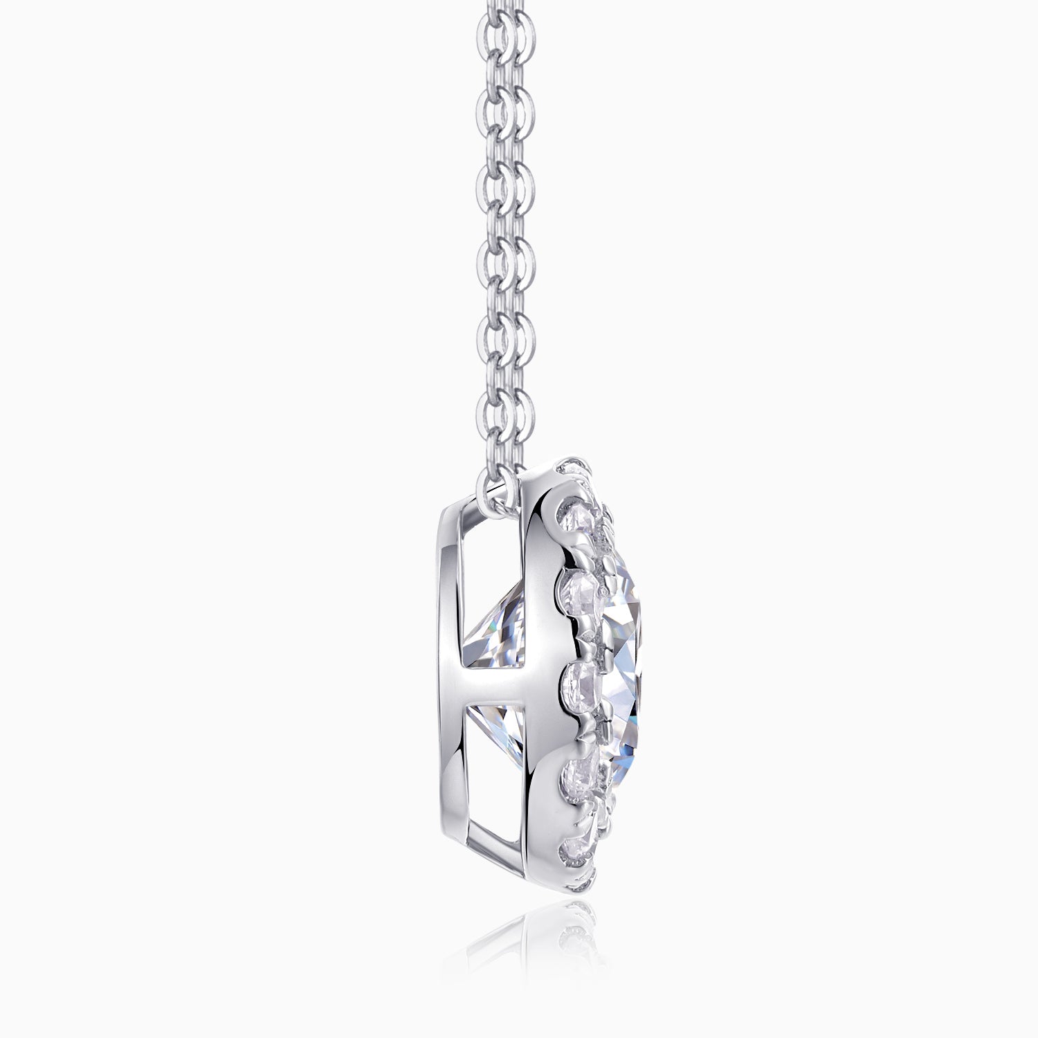 Side view of round halo moissanite pendant in silver-tone setting on link chain