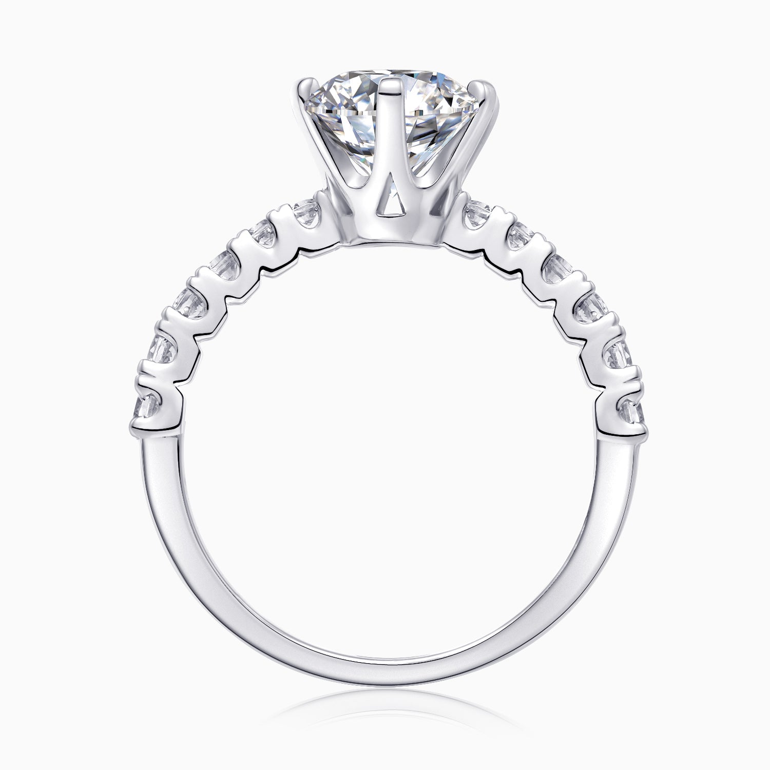 Top close-up of round moissanite ring, prong setting and pavé band details