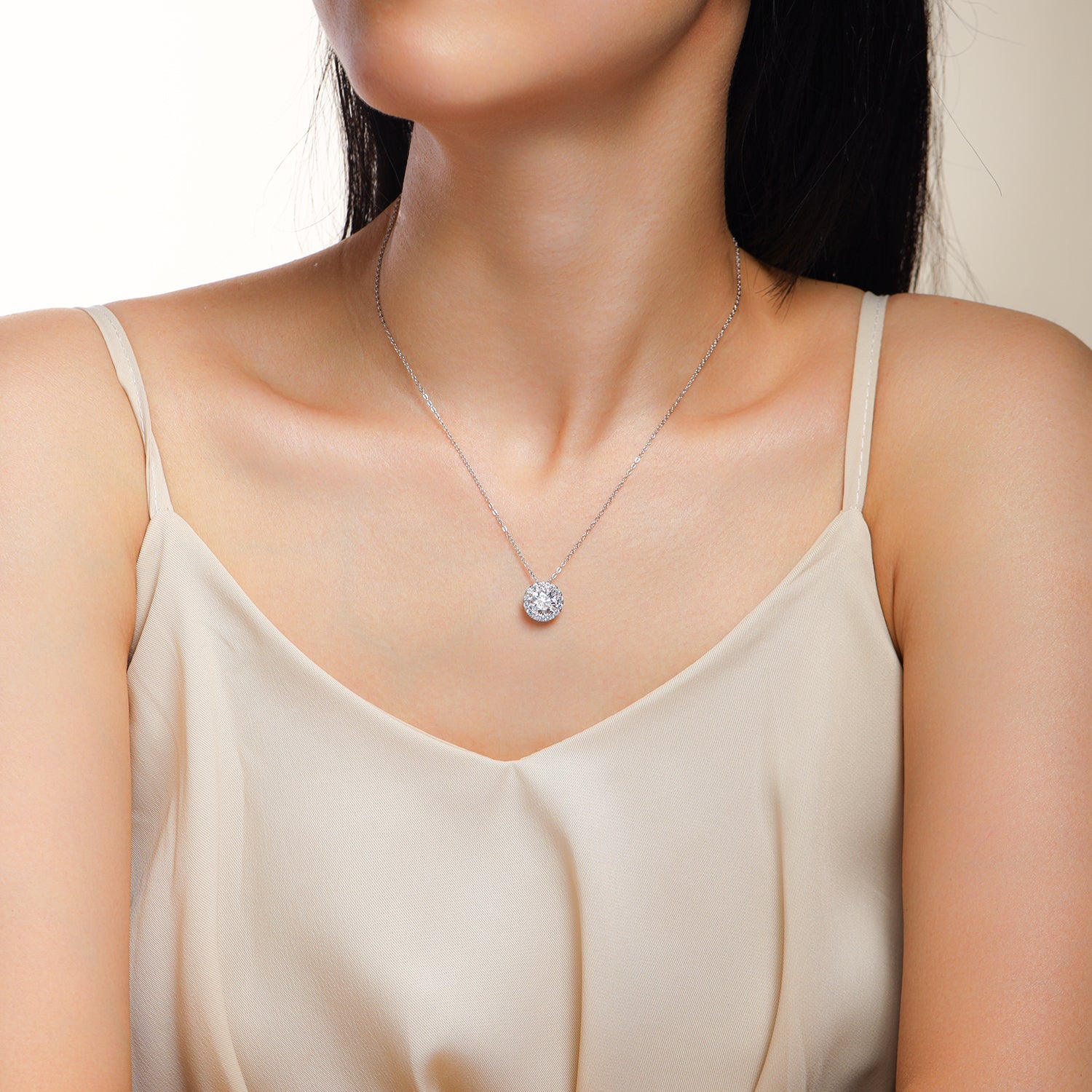 Moissanite pendant necklace on neckline, round halo center stone, silver-tone chain links