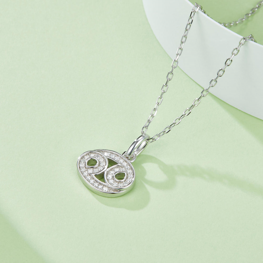 Cancer symbol moissanite pendant, oval setting with green centers and glittering pave