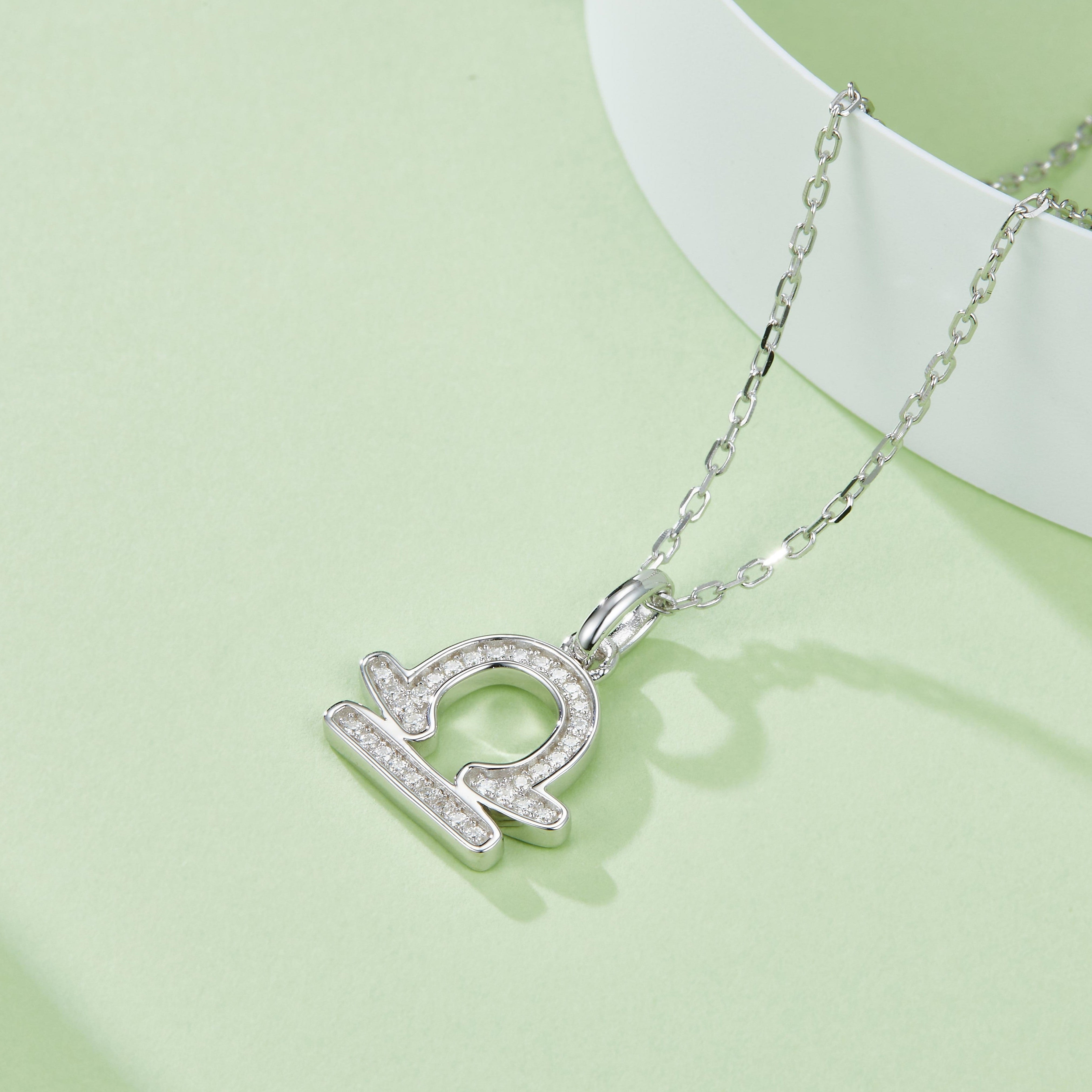Libra zodiac pendant necklace, angled view with sparkling stone border