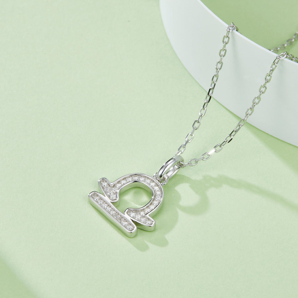Libra zodiac pendant necklace, angled view with sparkling stone border