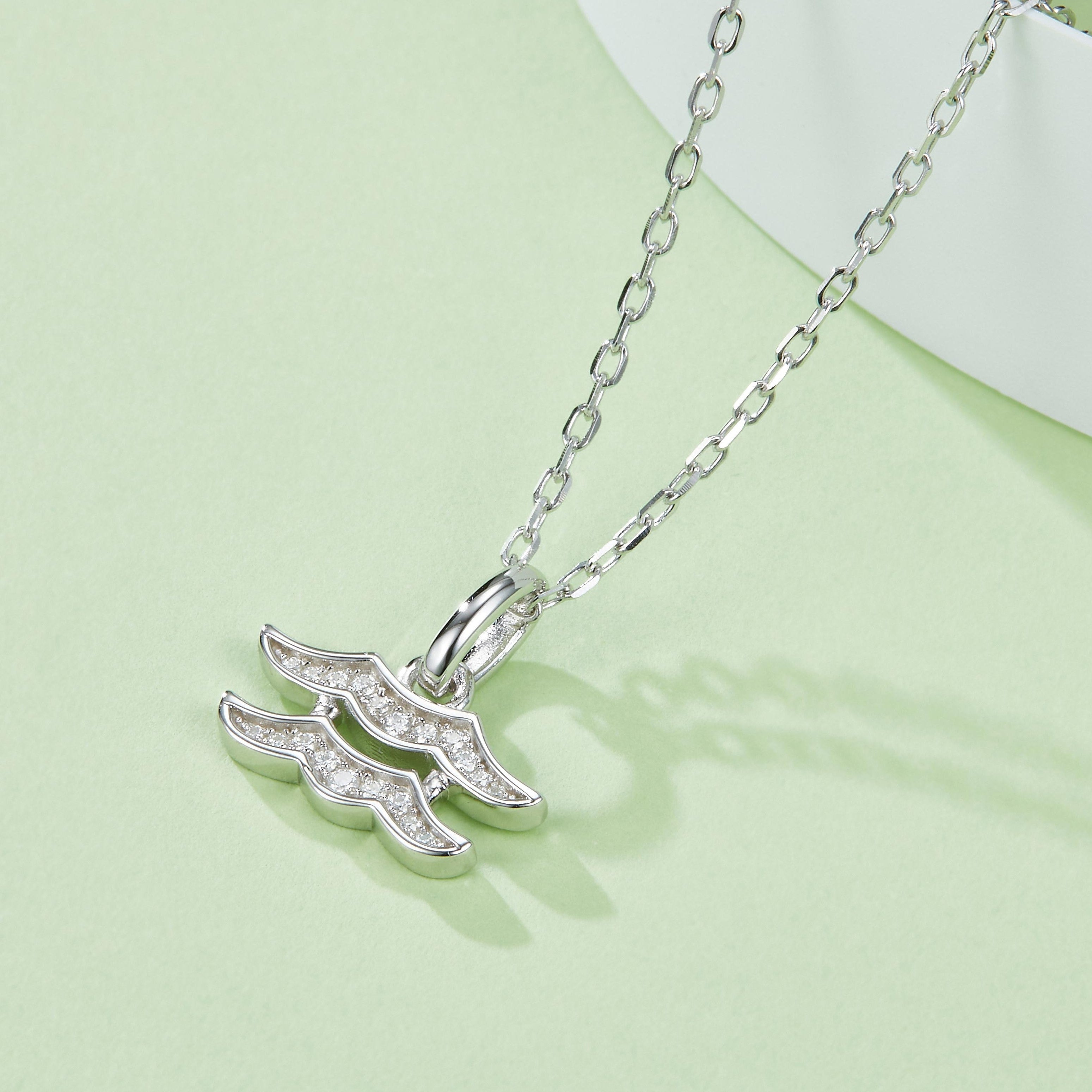 Aquarius pendant necklace, side view of wave glyph with sparkling stones on silver links