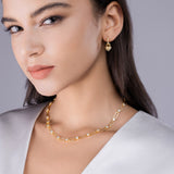 Yellow gold vermeil moissanite station chain necklace on model, close-up at neckline