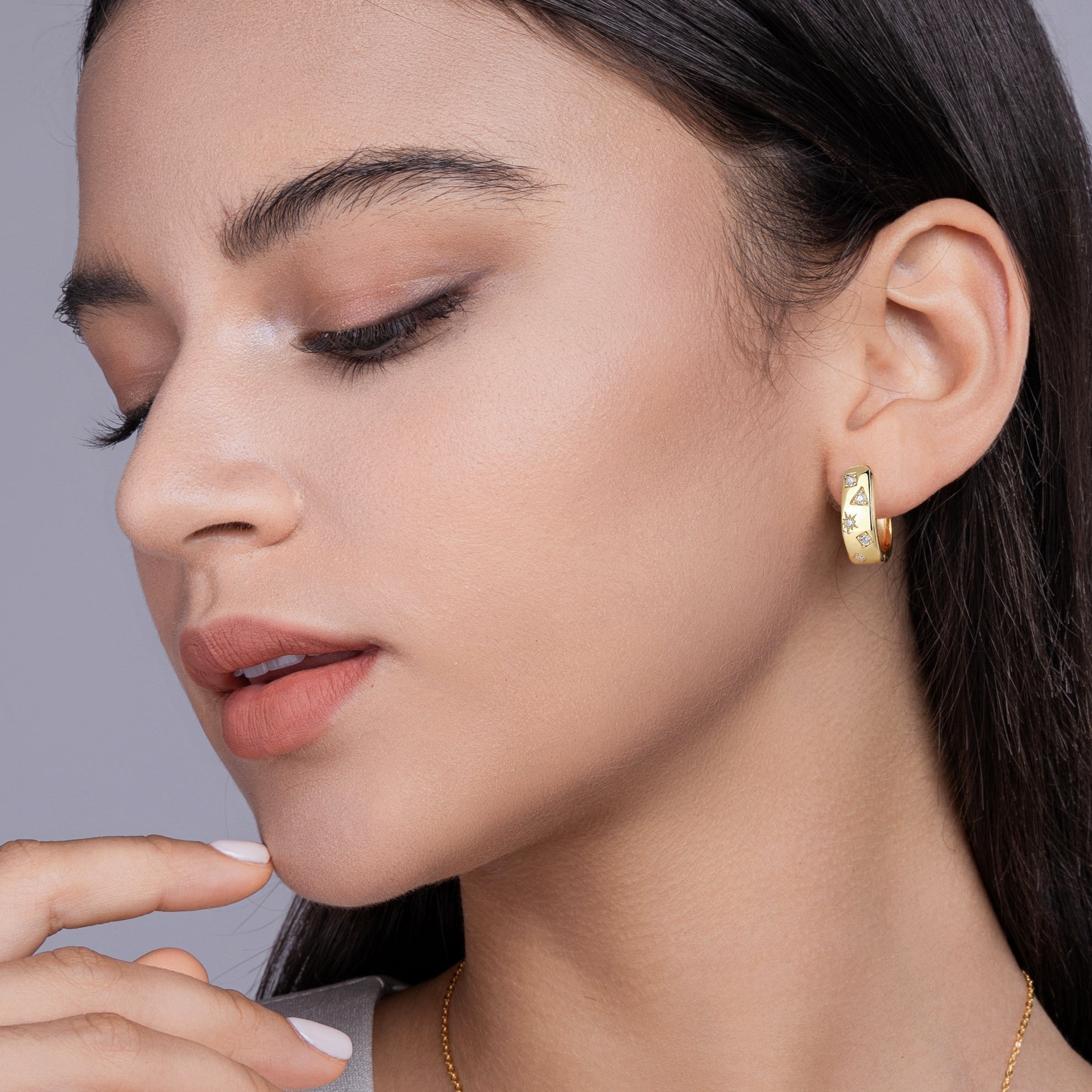 Earrings on ear: yellow gold vermeil huggie hoops with star, square, triangle stones