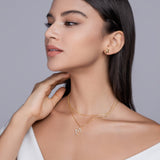 Model wearing yellow gold vermeil double-layer M necklace with moissanite stones