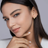 Yellow gold vermeil huggie hoop earrings with marquise moissanite bezel, worn