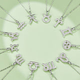 Zodiac moissanite pendants on silver-tone chains, assorted symbols with pave detailing