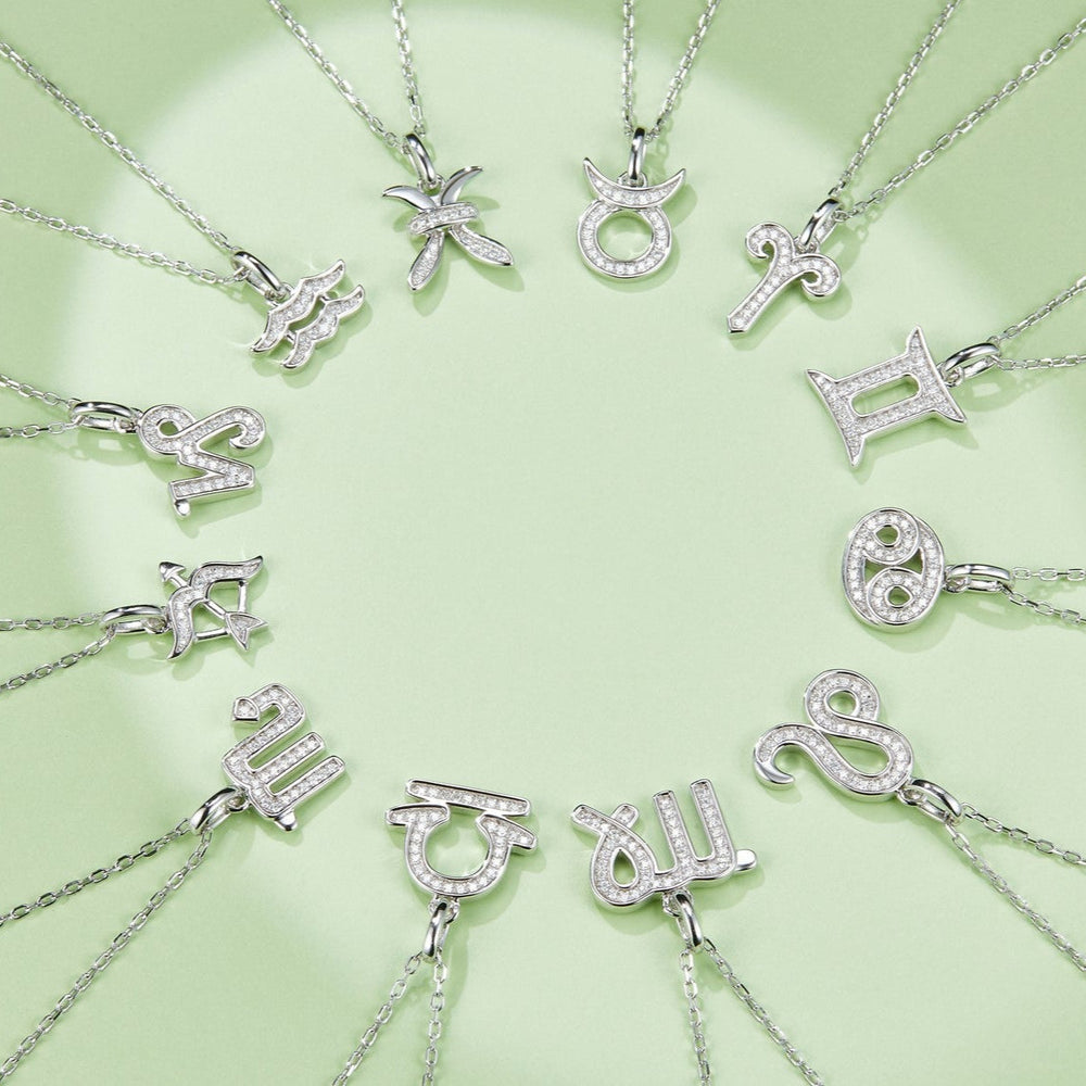 Zodiac moissanite pendant necklaces on chains, including a Sagittarius charm