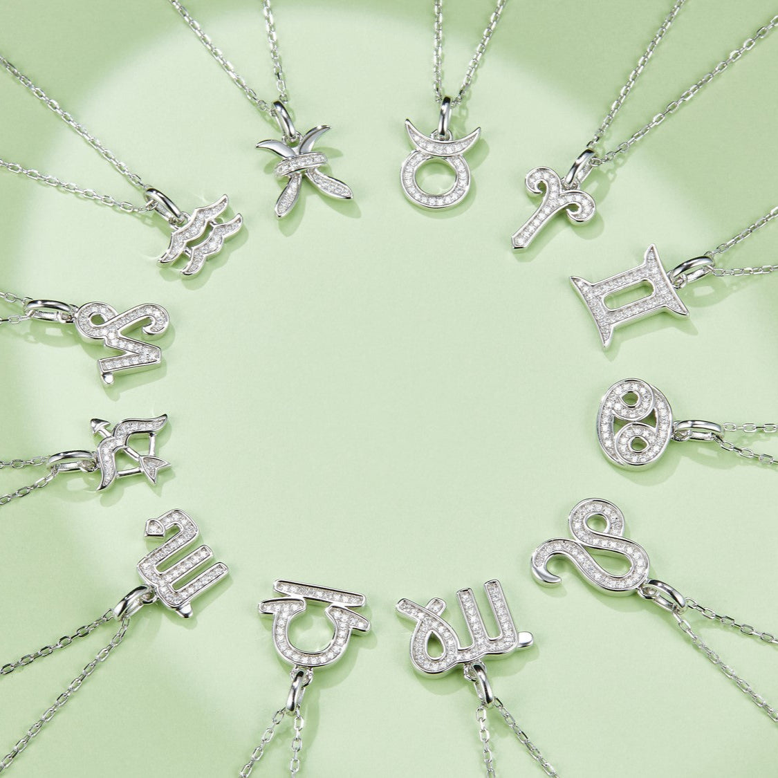 Multiple zodiac pendant necklaces on chains, jeweled charms in white gold vermeil