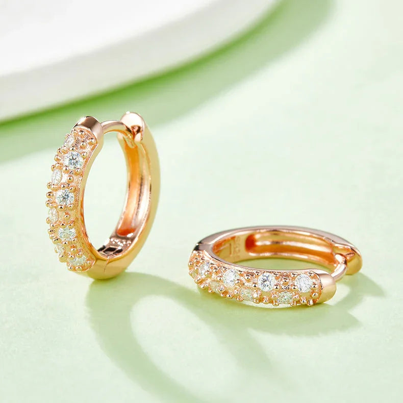 Rose gold vermeil half-pavé huggie hoop earrings, angled view of the stone-studded arc