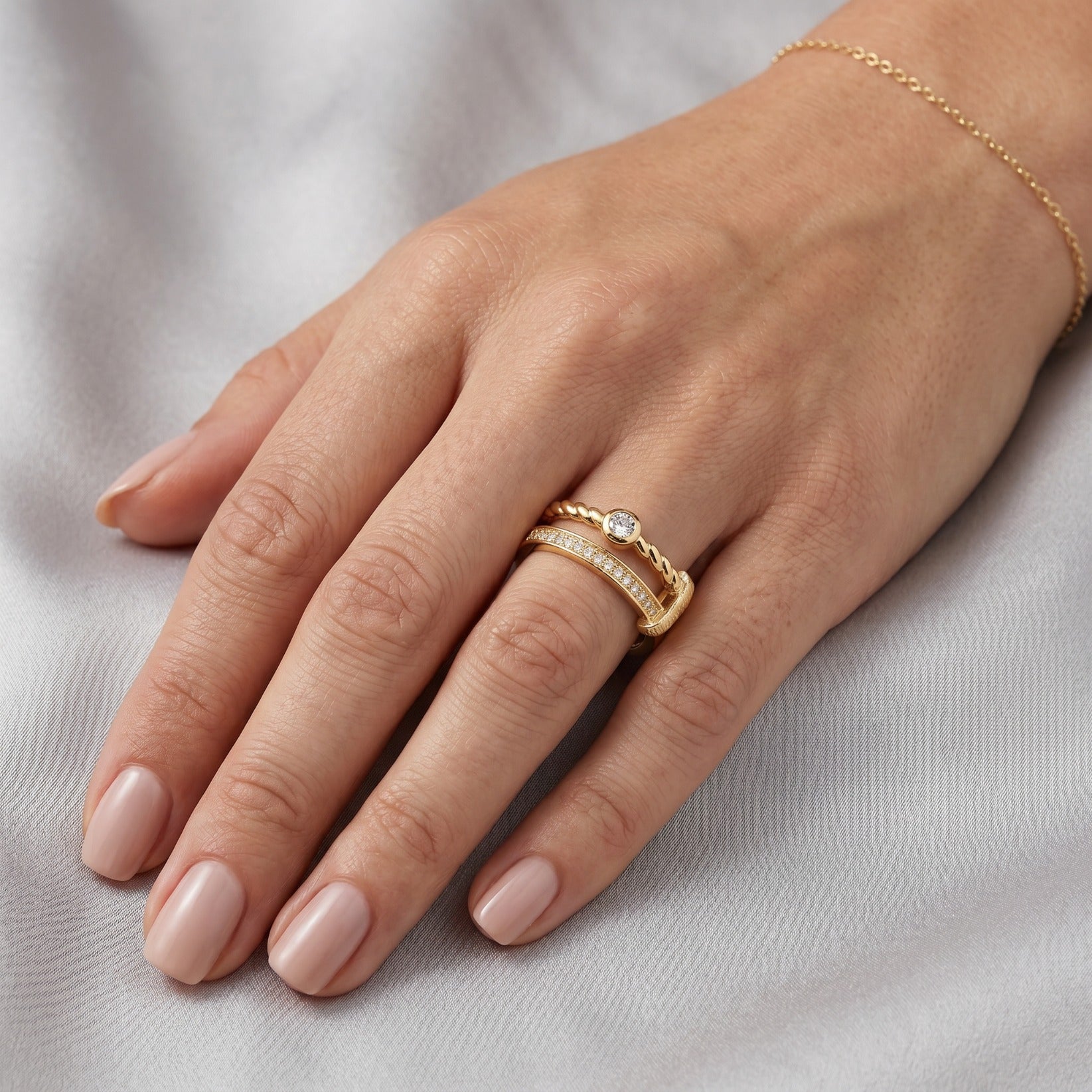 Double-band ring on finger, yellow gold vermeil with twisted rope band and pavé stones