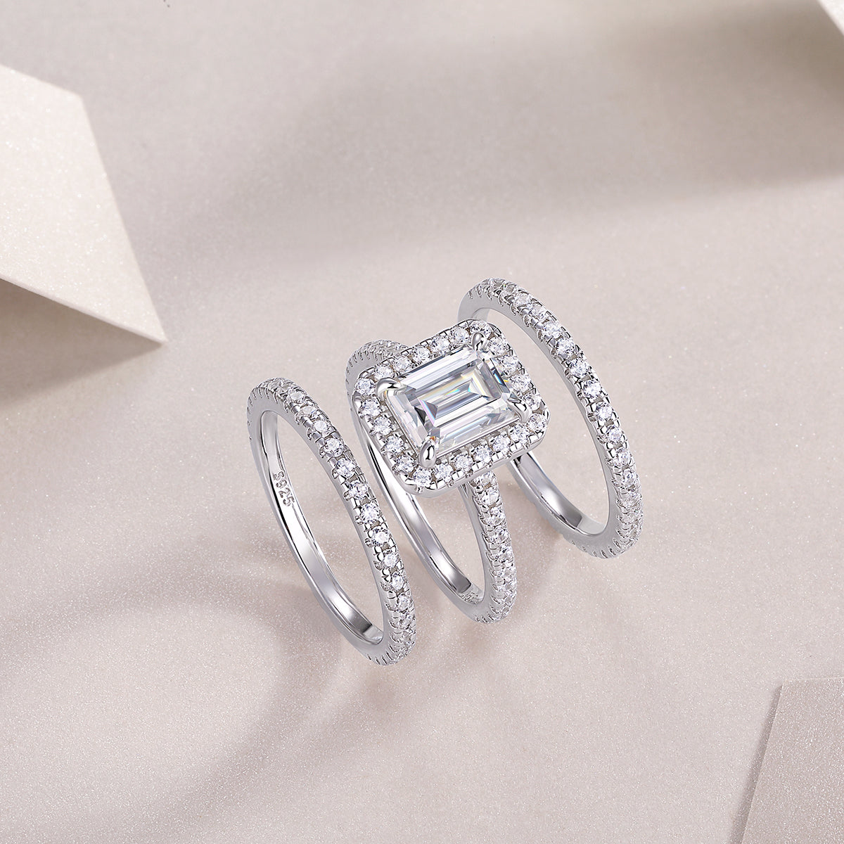 Emerald-cut halo ring with pavé accents shown stacked, white gold vermeil