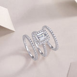 Emerald-cut halo ring with pavé accents shown stacked, white gold vermeil
