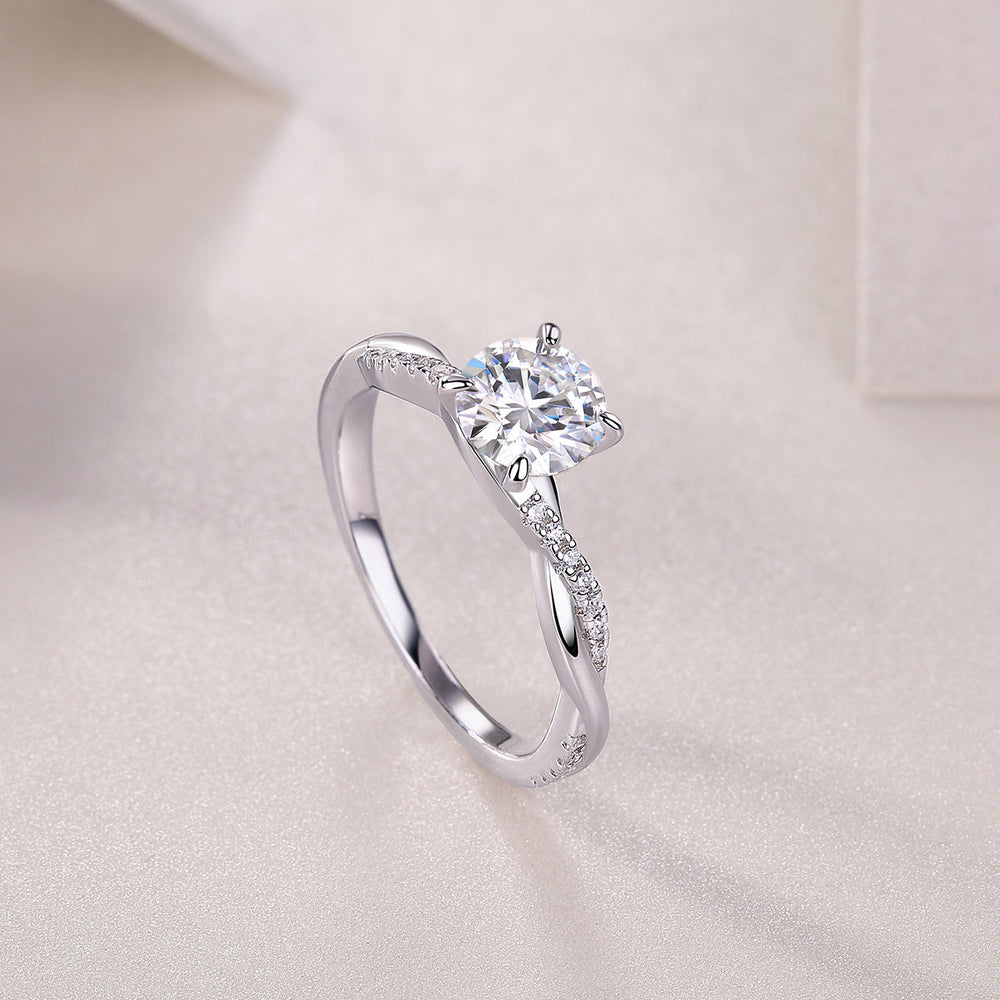 Round cut moissanite pavé ring, angled view of round center stone and pavé shank