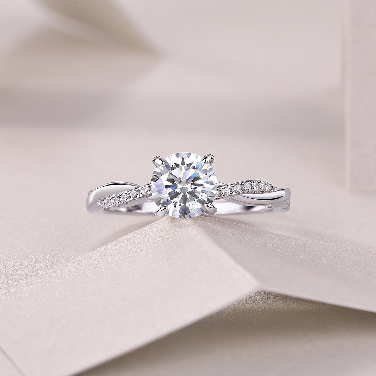 Round cut moissanite pavé ring, close view of round center stone and curved pavé band