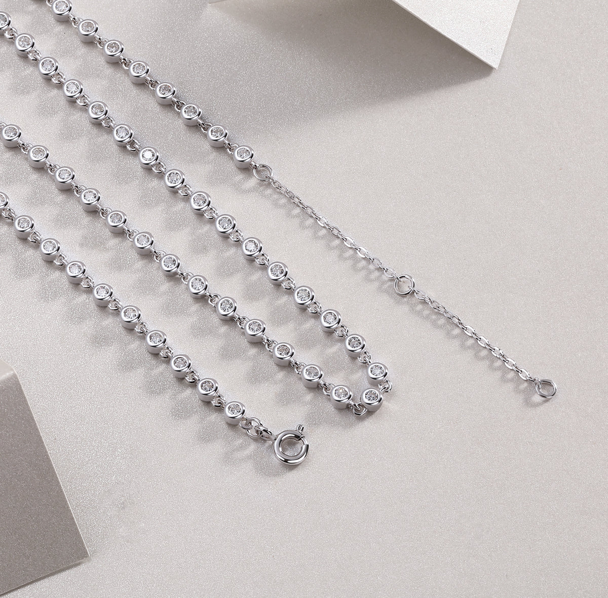 Tennis necklace clasp view with round bezel-set stones, white gold vermeil chain