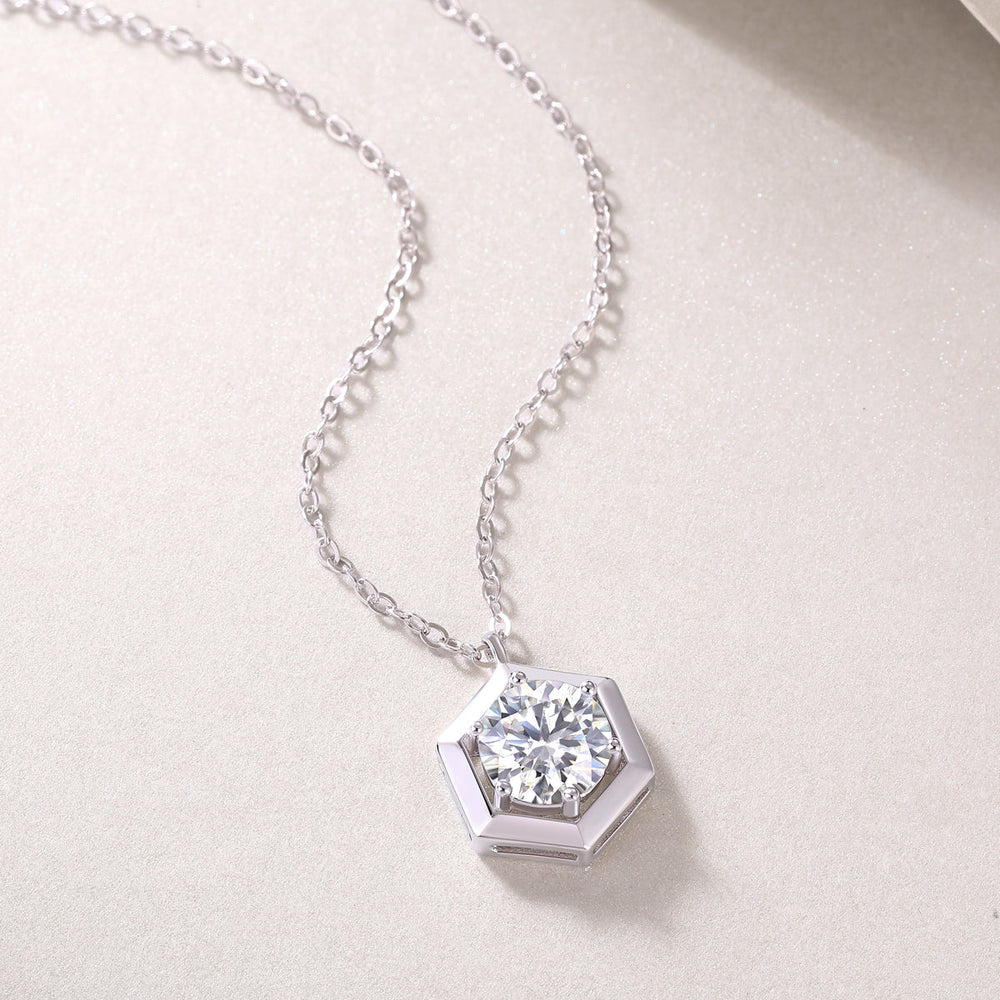 Close-up hexagon frame moissanite pendant, round brilliant stone, white gold vermeil