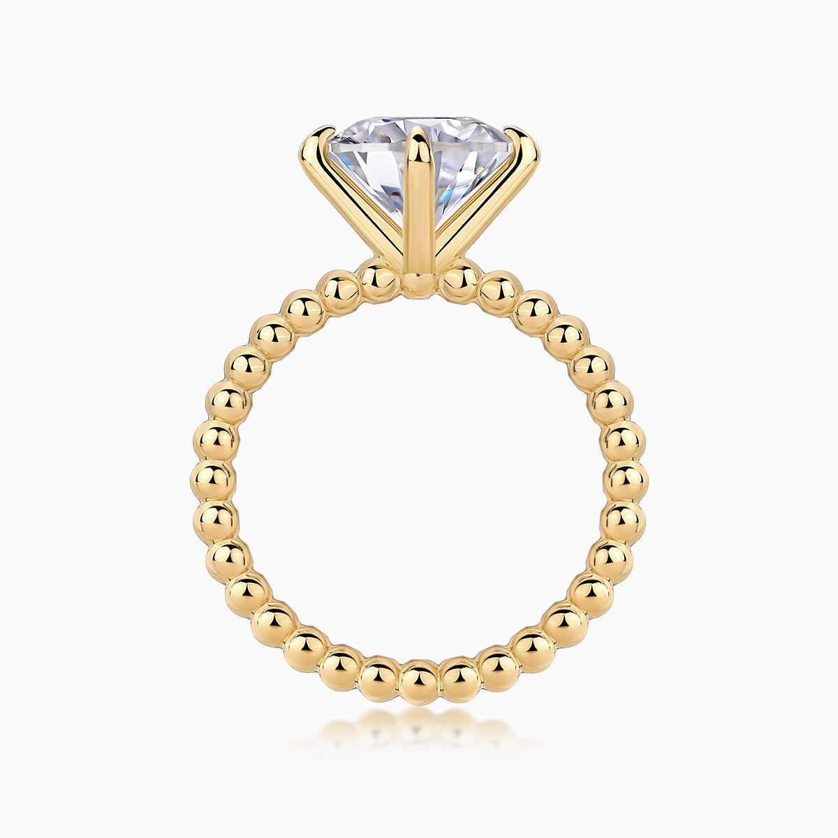 Solitaire round-cut moissanite ring with yellow gold plated beaded shank and raised prongs
