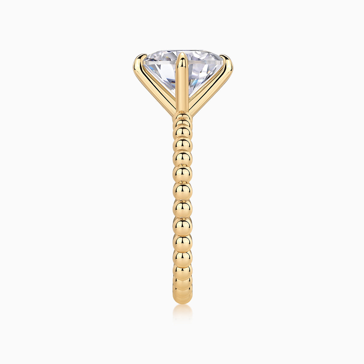 Profile of yellow gold plated solitaire ring with round moissanite center and beaded ring shank