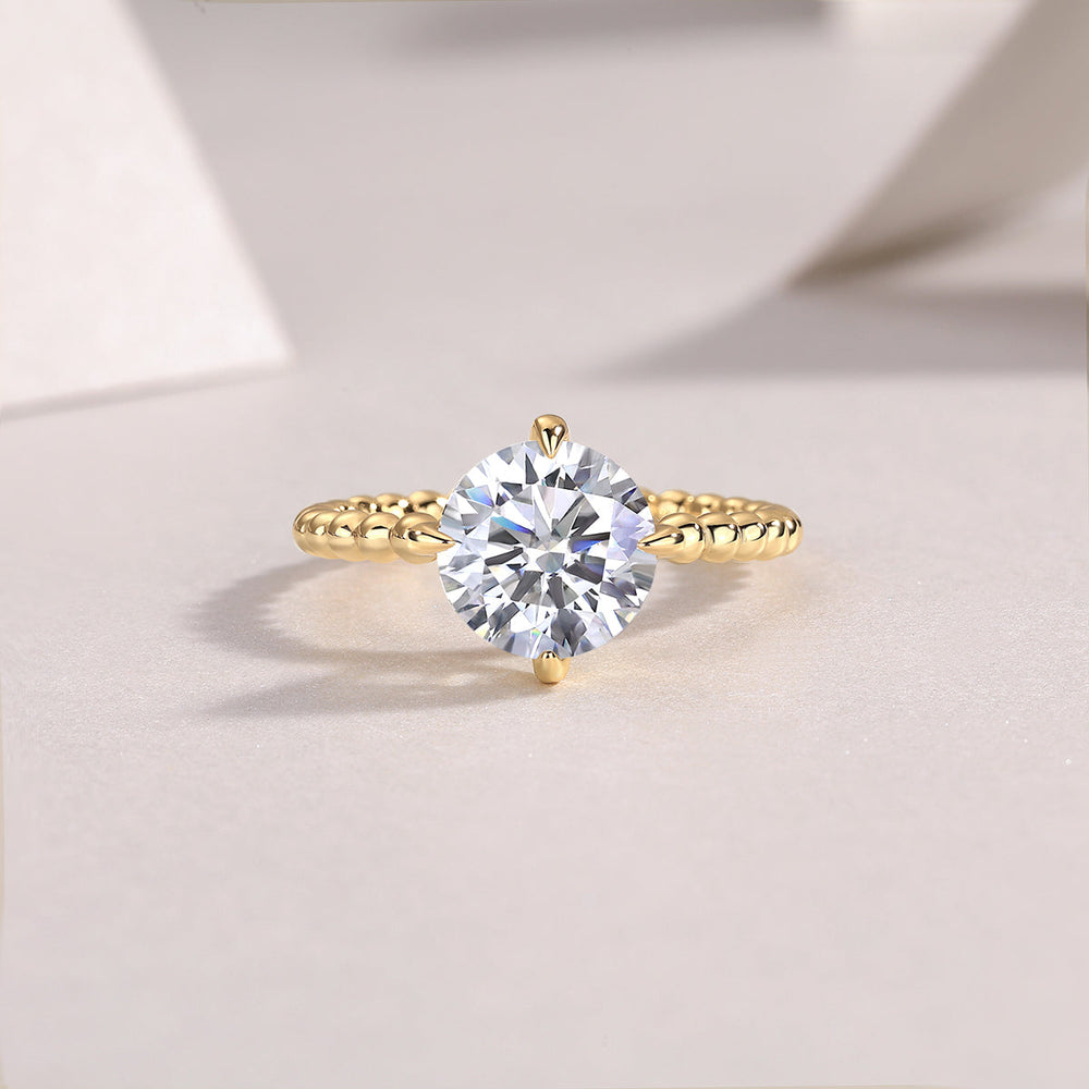 Round moissanite solitaire ring in yellow gold plated with beaded shoulders and prong setting