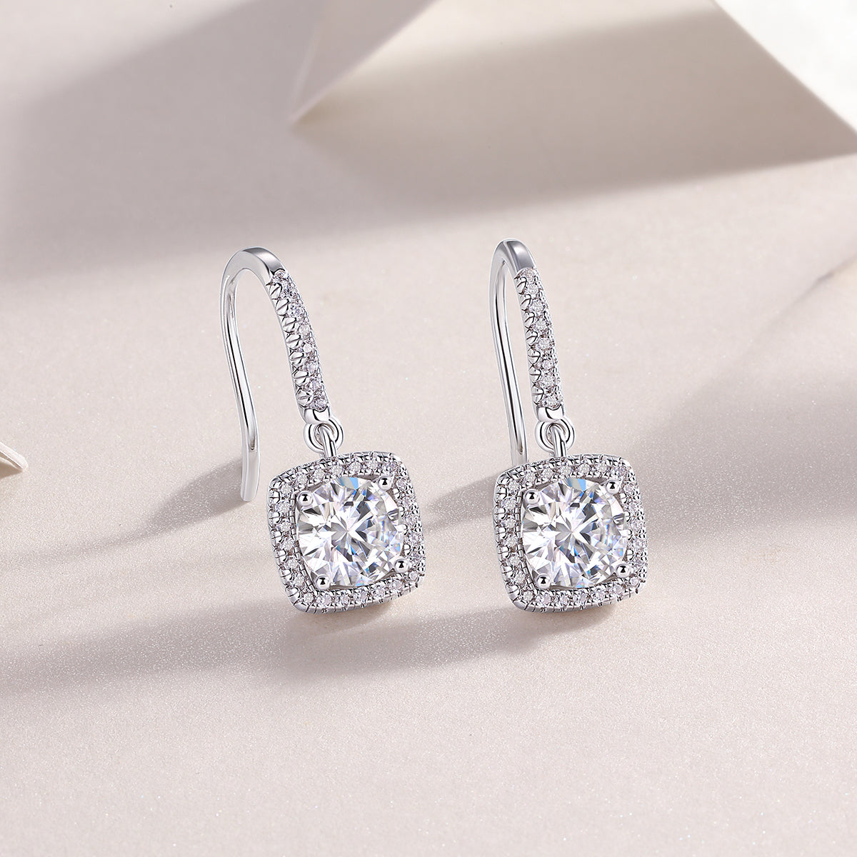 Cushion halo drop earrings with rounded cushion centerpiece and pavé surround, white gold