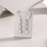 Three-stone moissanite drop earrings with round bezels and lever hook, white gold vermeil