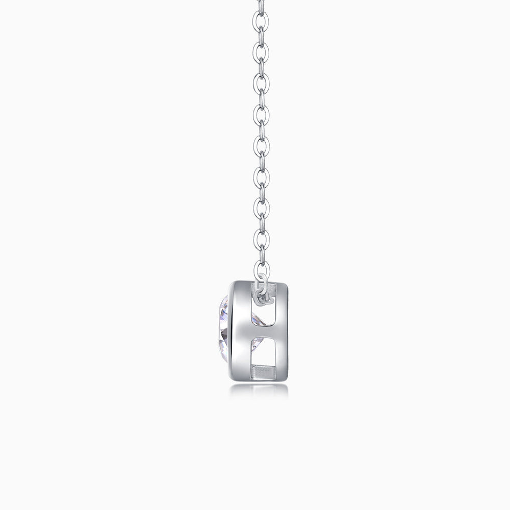 Back view of round bezel-set moissanite solitaire pendant on silver-tone chain