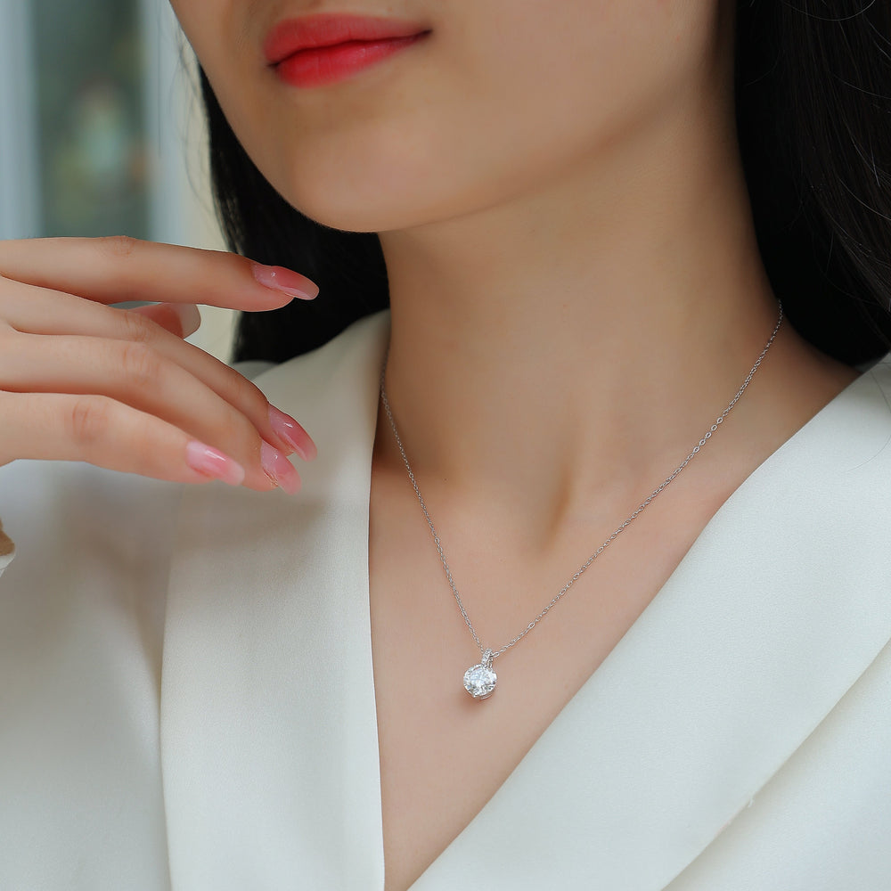 Model-worn solitaire moissanite necklace with round center stone, white gold vermeil chain