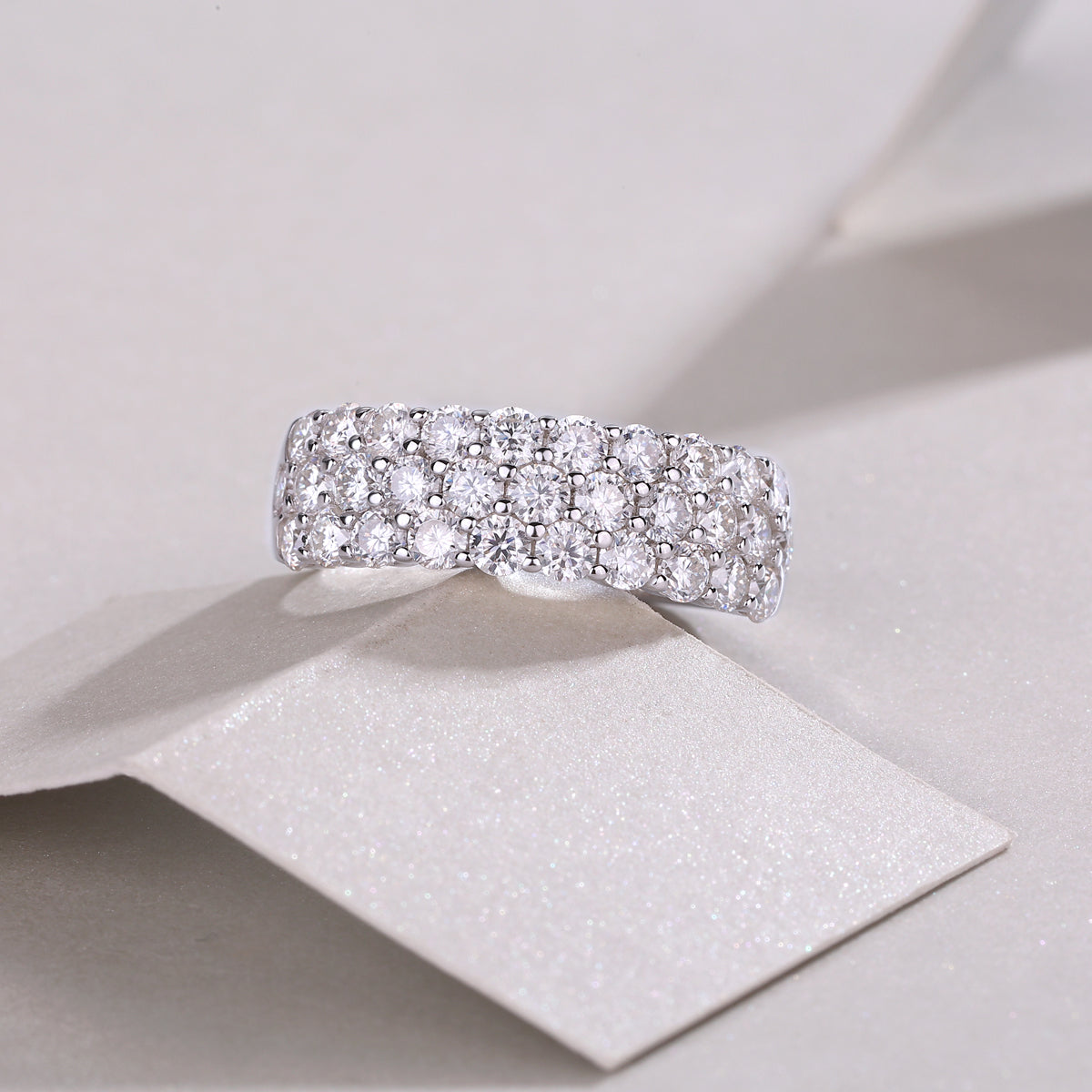 Triple-row moissanite eternity band with prong-set round stones, white gold