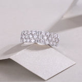 Triple-row moissanite eternity band with prong-set round stones, white gold