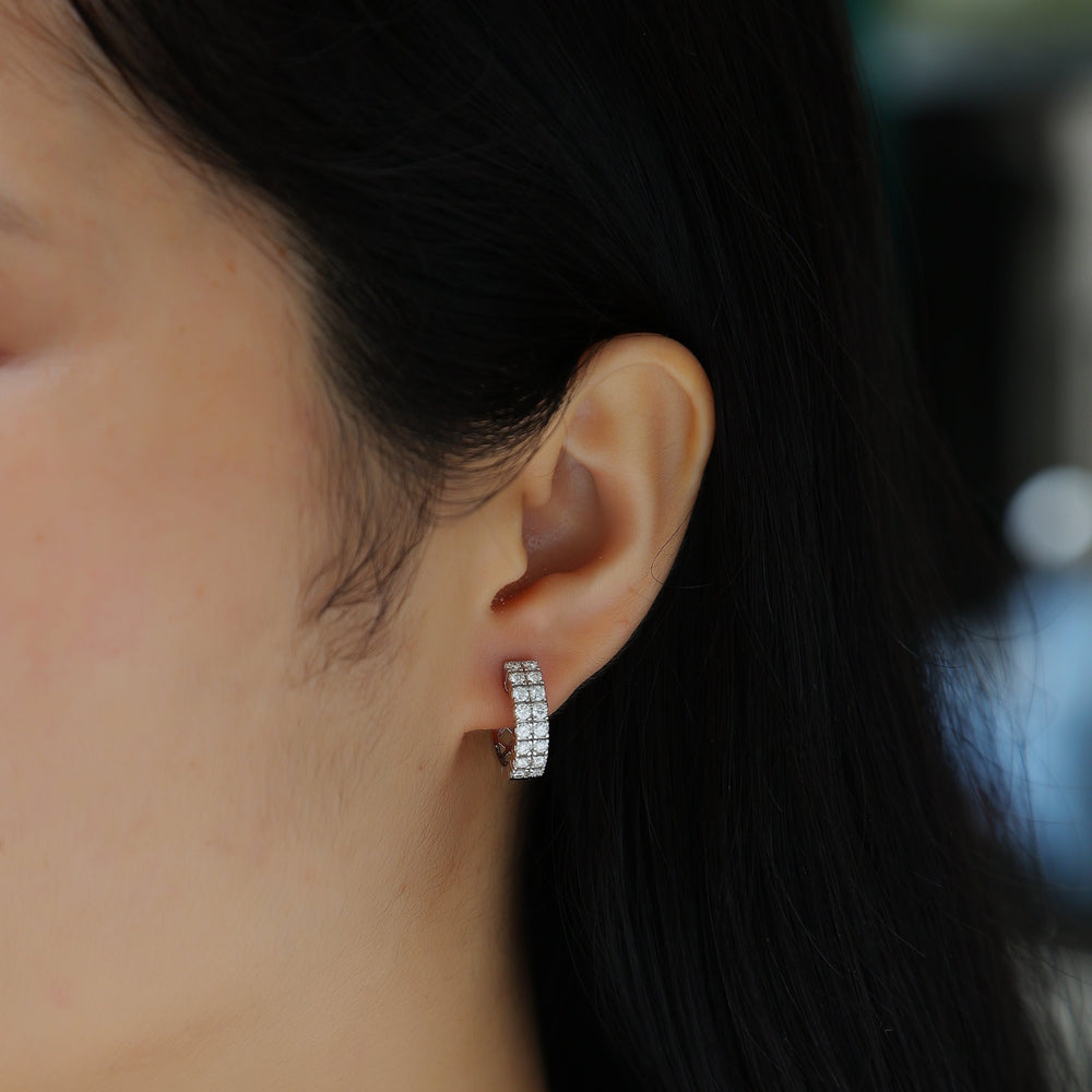 On-ear close-up: double-row huggie hoops with clear moissanite pavé, vermeil finish