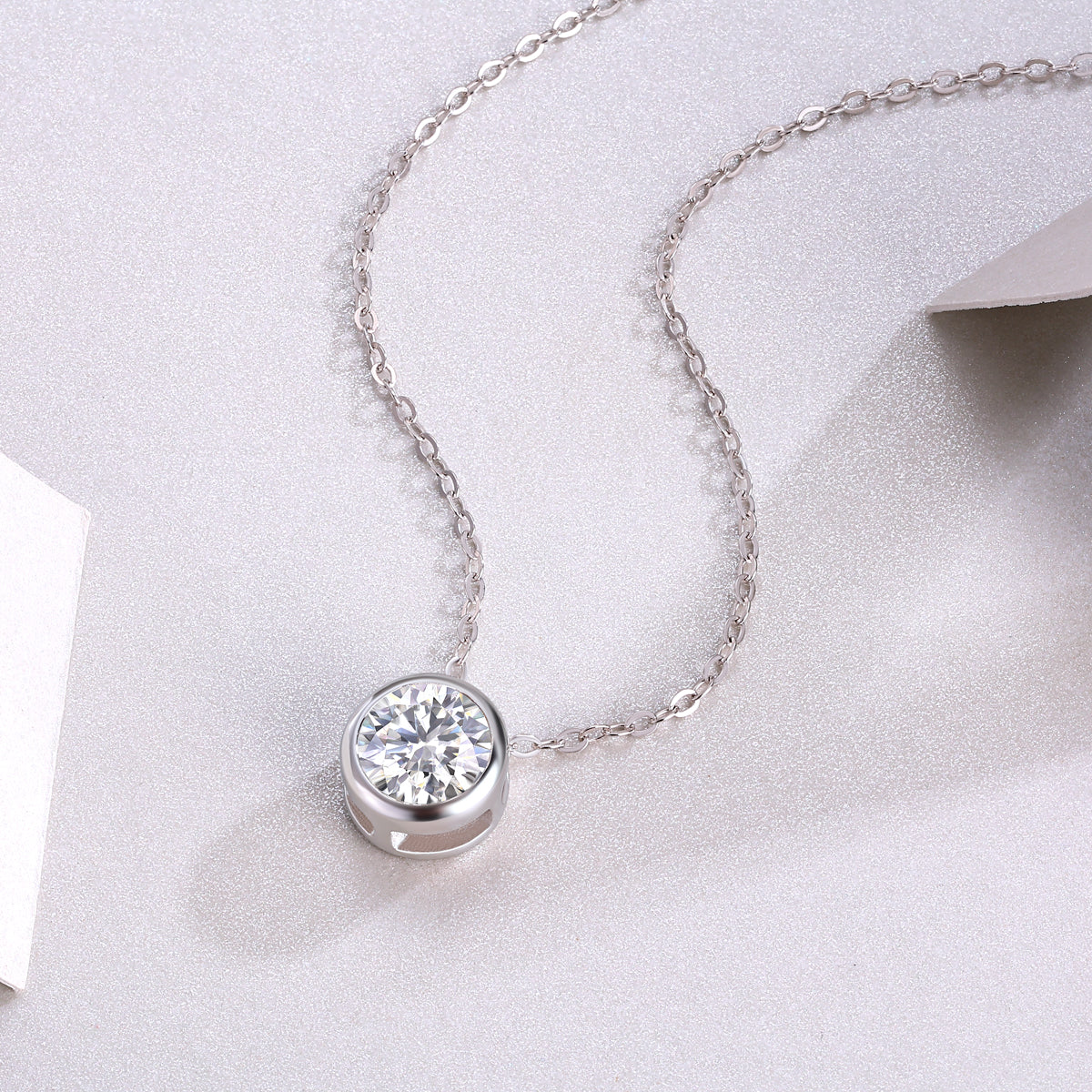 Round moissanite solitaire pendant in bezel with chain links, white gold vermeil look