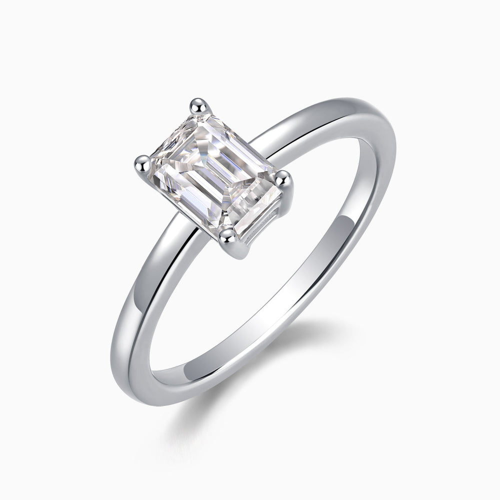 Solitaire emerald-cut moissanite ring, geometric center stone with four prongs