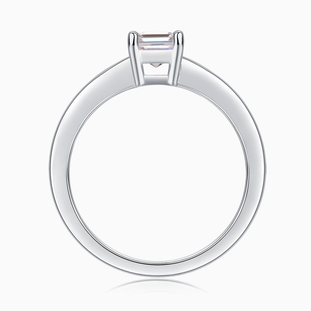 Solitaire emerald-cut moissanite ring, back view showing open prong basket