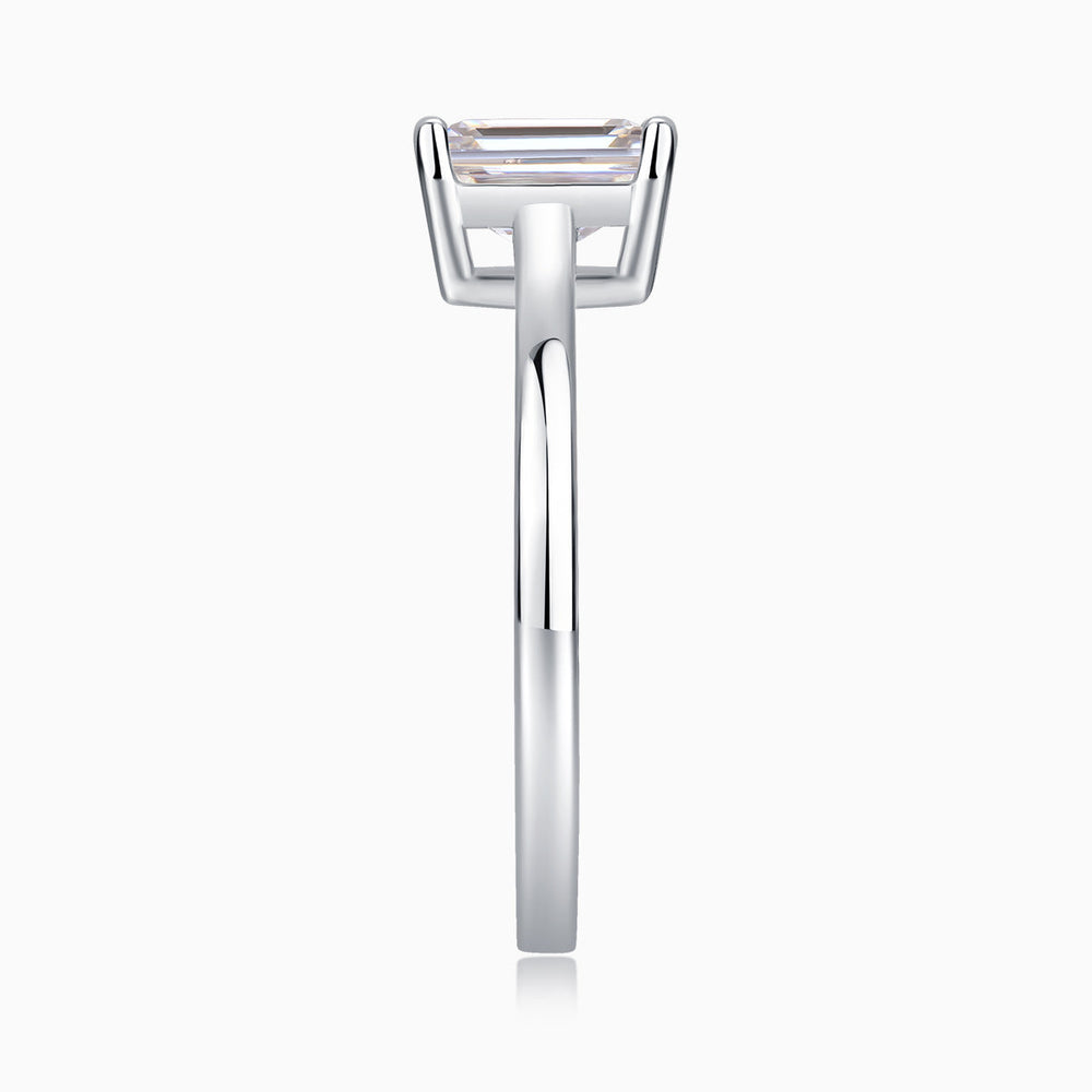 Solitaire emerald-cut moissanite ring profile, thin band with prong-set stone