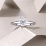 Solitaire emerald-cut moissanite ring, emerald-cut center stone in four-prong setting