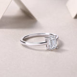 Solitaire emerald-cut moissanite ring, side view of band and prong setting