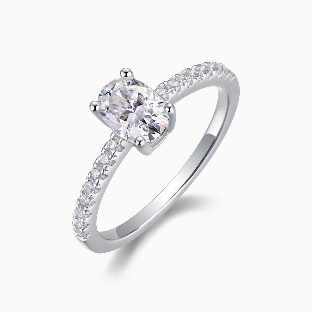 Oval-cut moissanite engagement ring, pavé side stones and polished metal band