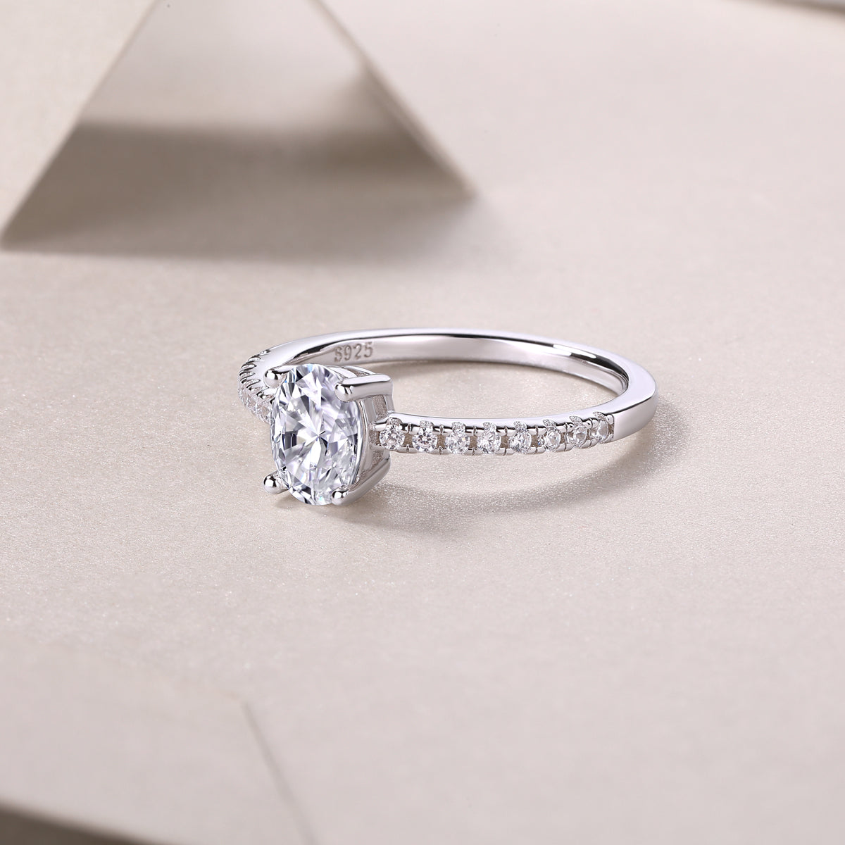 Engagement ring side profile with oval moissanite center stone and pavé row on band