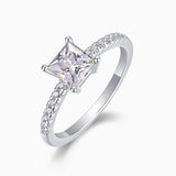 Angled view: white-gold vermeil princess-cut moissanite ring with pavé band