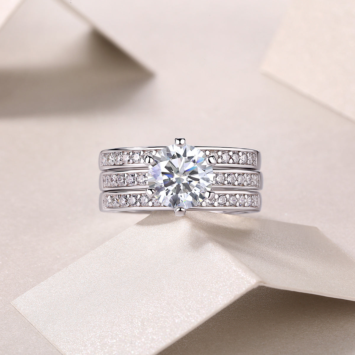 Front view of 3-piece stackable ring set with round moissanite and pavé rows