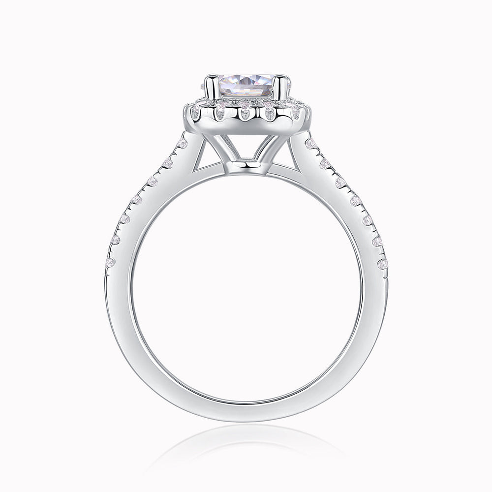 Round halo pavé moissanite ring, side view of center stone setting and prong basket