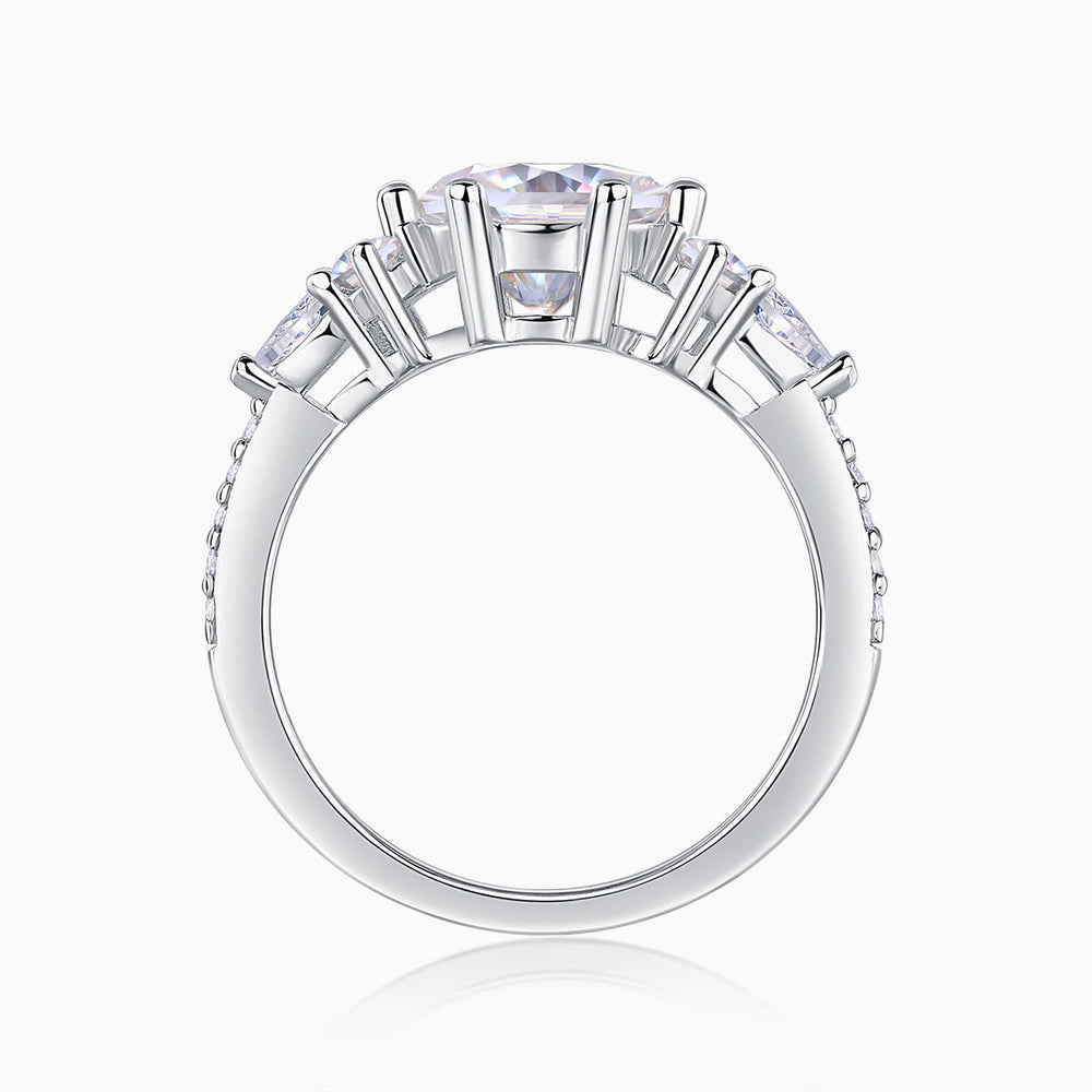 Round moissanite pavé ring top view, white gold setting with prongs and pavé details