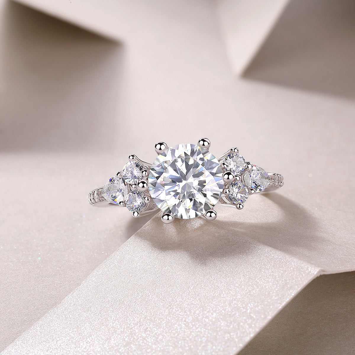Round moissanite pavé ring with central round stone and small side stones, white gold