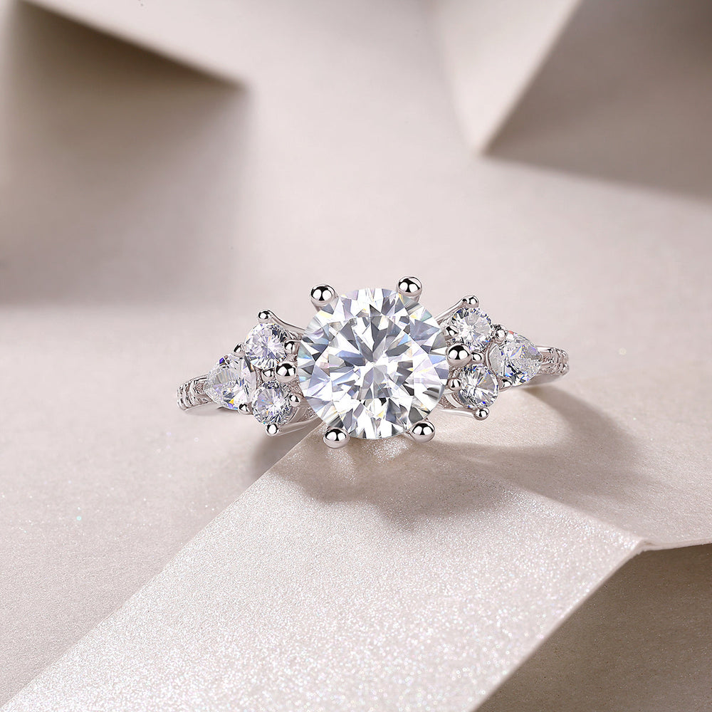 Round moissanite pavé ring with central round stone and small side stones, white gold